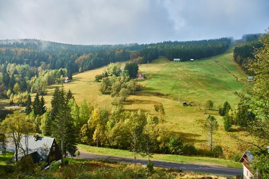 pastures and ski slopes in Harrachov during sunny autumn day