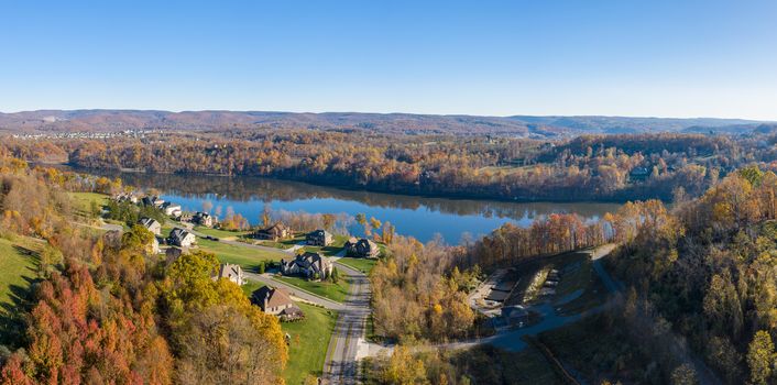 Aerial drone panorama of single family houses by Cheat Lake near Morgantown in autumn
