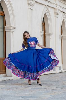A gorgeous Hispanic Brunette model poses outdoors at a Mexican hacienda