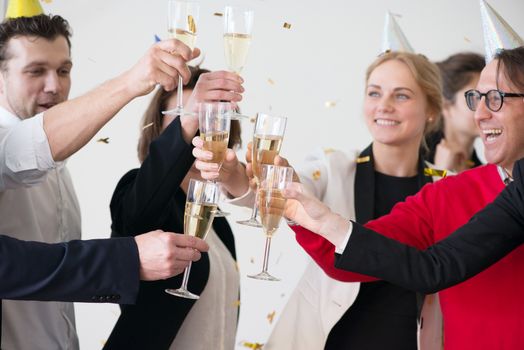 Business people drink champagne celebrating New Year at office party