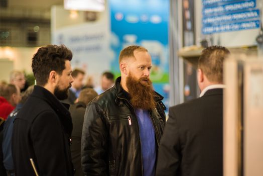 Group of men having a conversation at the convention trade center in Brno taking some time to have a coffee. BVV Brno Exhibition center. Czech Republic