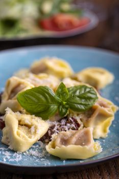 tortellini with olive oil on a blue plate