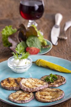 grilled eggplant with tsatsiki on wood