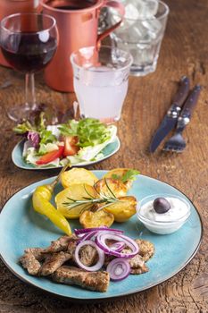 greek gyros with salad and ouzo