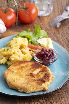 celery schnitzel with potato salad and cranberries