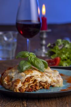 fresh lasagna on a blue plate