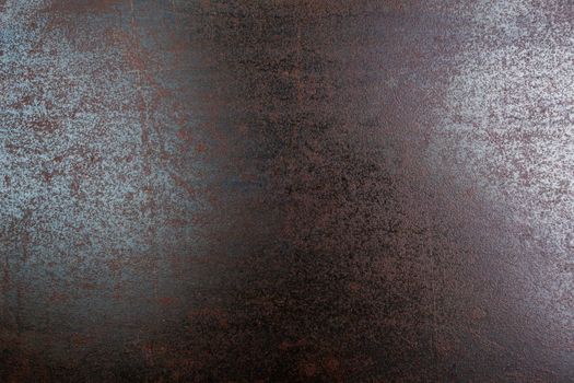 rusted black steel sheet surface covered with machine oil in flat lay perspective