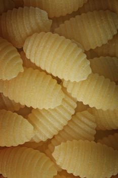 Italian pasta called gnocchetti sardi or Sardinian gnocchi, dumplings of durum wheat semolina , studio shot , a heap of pasta , top view