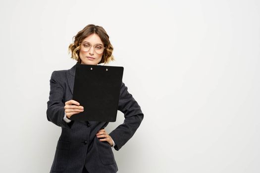 business woman in a suit with documents in hands light background curly hair hairstyle. High quality photo