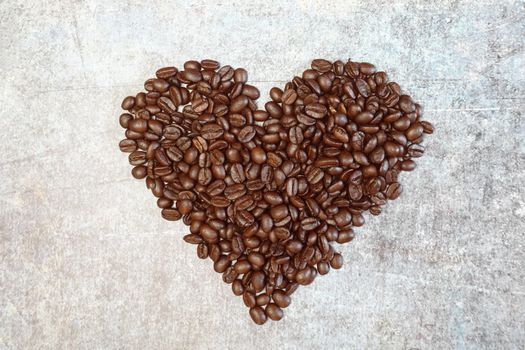Roasted coffee beans in heart shape.