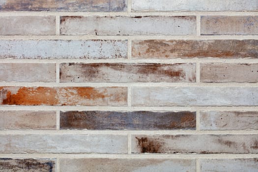 Texture and background of a wall made of old long bricks in the form of brickwork.