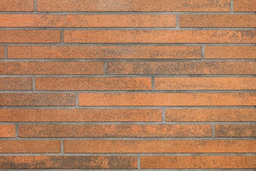 Decorative brown wall surface with smooth horizontal stripes and imitation of brickwork.