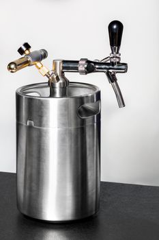 A new clean stainless steel barrel and a tap on it, copy space.