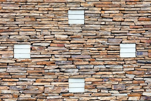 Part of a sandstone stone wall with silicate brick ornaments, expressive texture and background in high resolution.