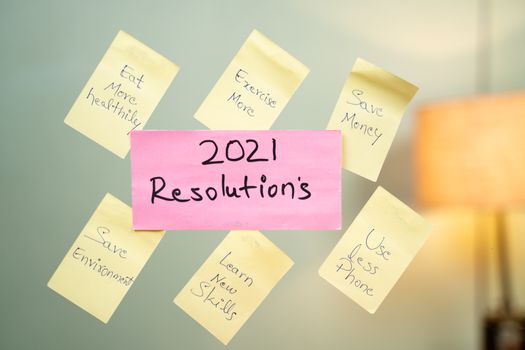 Pasted common 2021 new year resolution written sticky notes on wall