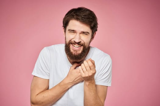 cheerful bearded man white t-shirt emotions cropped view pink background. High quality photo