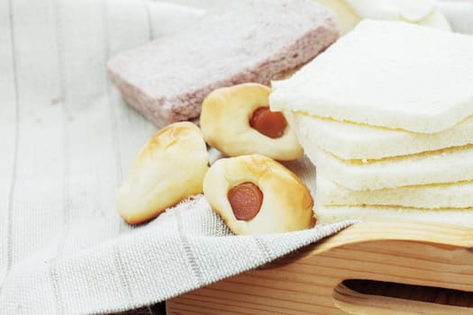 Many of breads on a tablecloth.