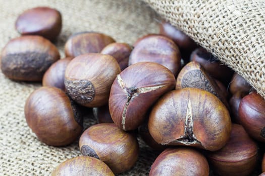 Roasted chestnuts on old sack.