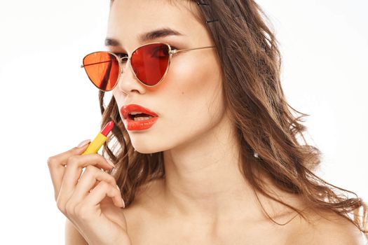 Fashionable brunette in sunglasses with makeup lipstick model. High quality photo