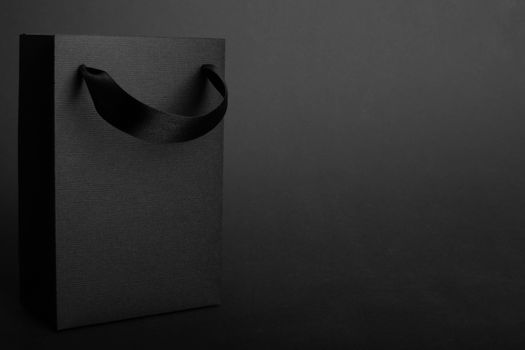 Black Friday blank empty paper bag with copy space for text and logo on dark background sale concept