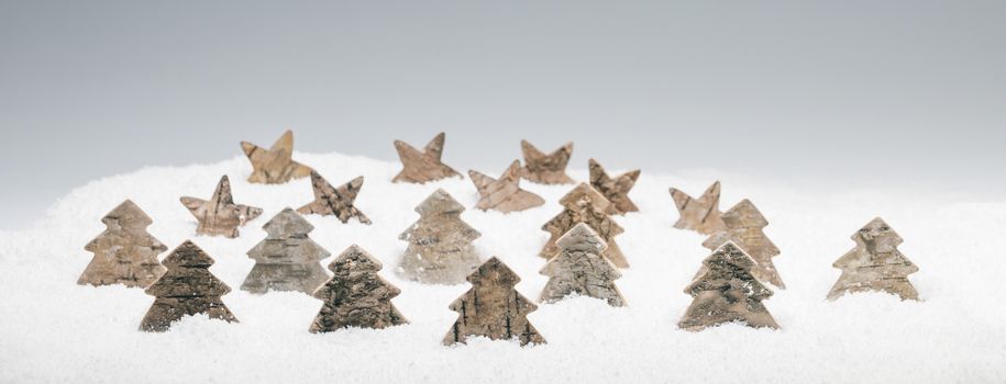 Wooden eco-friendly Christmas decor in snow, trees and stars made of birch bark