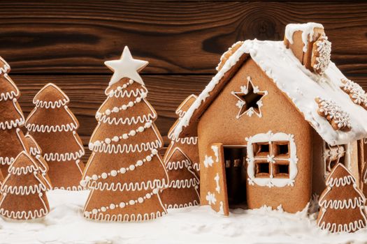 Gingerbread house christmas fir trees cookies in snow winter holiday celebration concept
