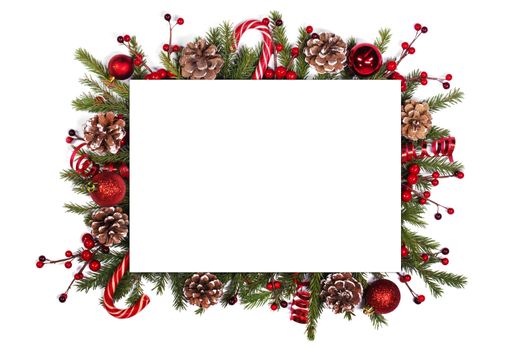 Christmas white blank card with copy space and decor of fir tree branch bauble candy cane pine cone red holly berry isolated on white background