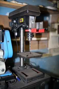 drill press with a drill inserted. Metal drilling