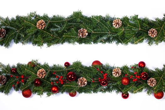 Christmas frame decor of fir tree branch cones red holly berry baubles isolated on white background