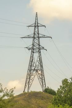 power line tower with wires against the blue sky,vertical snapshot