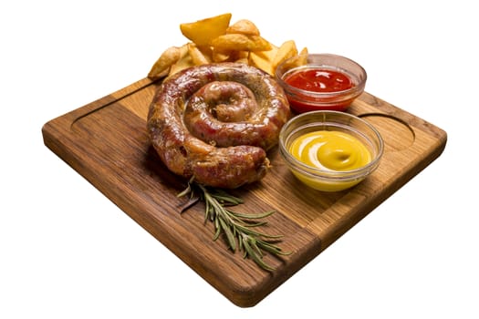 Grilled sausages with french fries with ketchup sauce and mustard on a wooden stand. Isolated image on a white background.