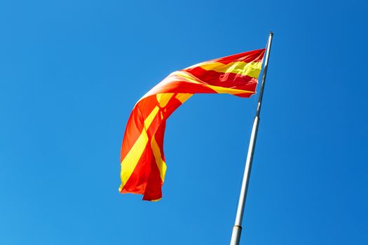 North macedonia flag waving in sunny blue sky.