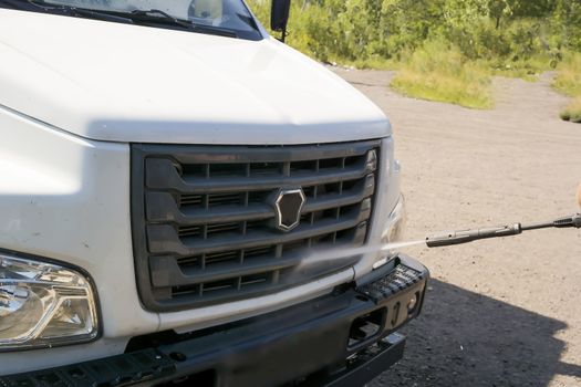 washing the truck with a high-pressure wash