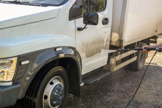 washing the truck with a high-pressure wash