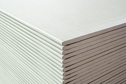 building material. drywall sheets are stacked on top of each other.
