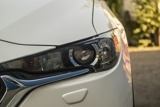 modern white car's close-up headlight.
