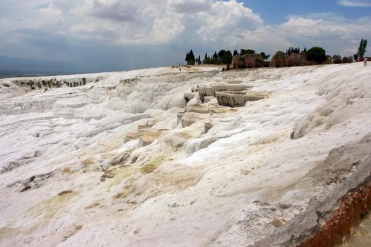 Pamukkale - natural travertine pools and terraces of Denizli, Turkey. Geothermal springs, stalactites, Geological area is famous for a carbonate mineral left by the flowing water.