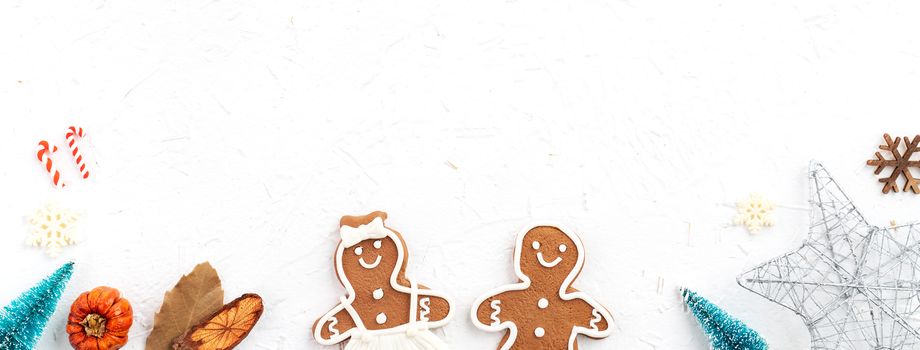 Top view of Christmas holiday decoration ornament composition with Christmas tree, gift star, gingerbread man flat lay with copy space isolated on white background.