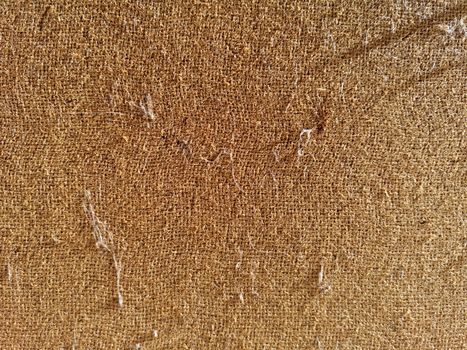 Rough fabric of light brown color, closeup, background texture.