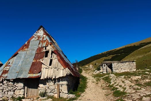An old Bosnian house with holes in the roof in the old Bosnian village of Lukomir on the Bjelasnica mountain.