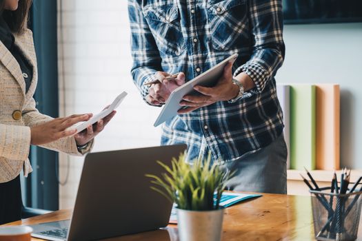 Business people meeting to discuss the situation on the market with tablet computer.