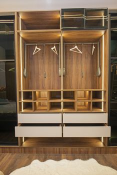 Interior design decor furnishing of luxury show home bedroom showing wooden wardrobe closet furniture