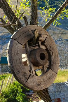 A wooden wheel hung on a tree in the old Bosnian village of Lukomir. Bjelasnica Mountain, Bosnia and Herzegovina.