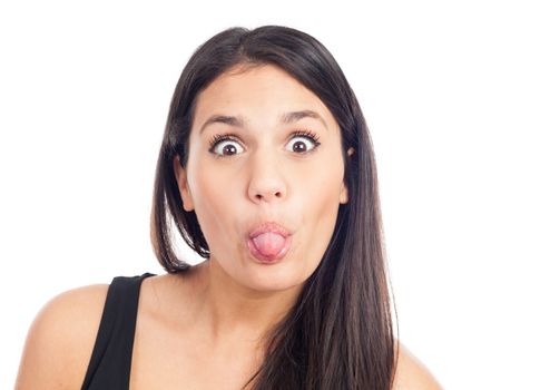 portrait of a happy young brunette woman laughing and pulling her tongue
