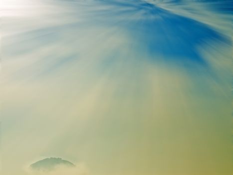 hill in morning light with fog