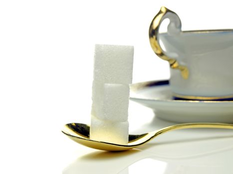 lump sugar with spoon and cup