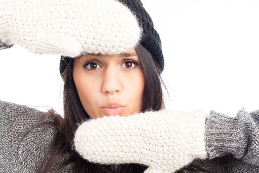 pretty brunette woman with a woolen hat a sweater and gloves smiling and cheerful