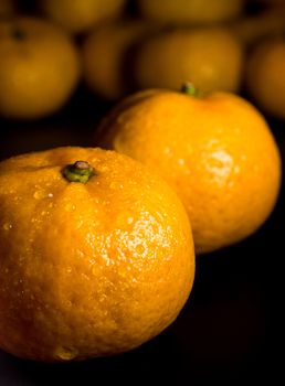 Close-up of Water droplet on glossy surface of freshness orange on black background