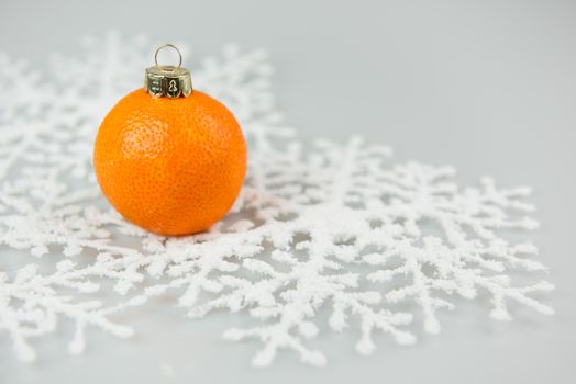 Tangerine as a xmas ball on Christmas and New Year isolated on a white background. Fir tree toy fruits concept design on holiday.