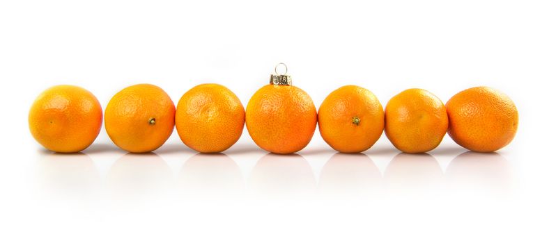 Tangerines as a xmas ball on Christmas and New Year. Russian tradition fir tree toy fruits holiday concept decoration design on holiday. Tangerines Row Line Isolated on white background.